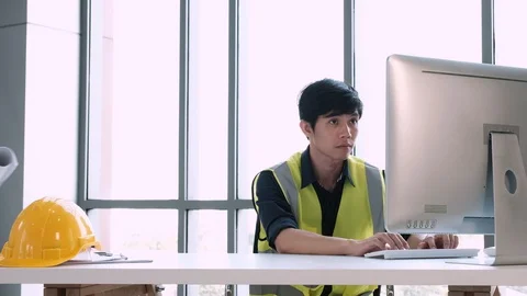 Engineer hold blueprint and took off safety helmet put on table Stock Footage 129585088