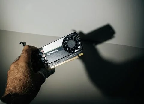 Engineer holding in dark server room new NVIDIA T600 video card with NVIDIA Stock Photos