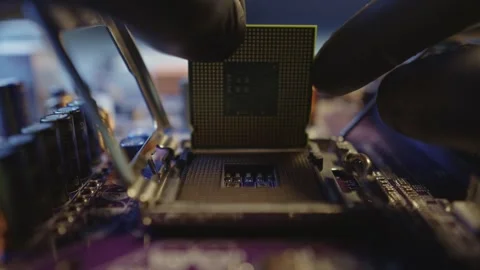 Engineer holding hands CPU to insert into the socket of the motherboard Stock Footage 284204333