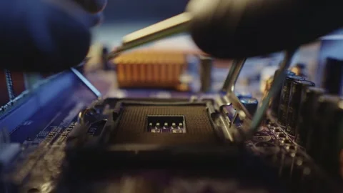 Engineer holding hands CPU to insert into the socket of the motherboard Stock Footage 284204341