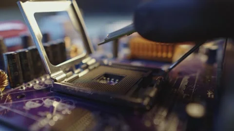 Engineer holding hands CPU to insert into the socket of the motherboard Stock Footage 284204512