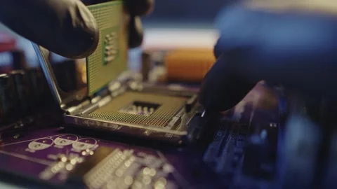 Engineer holding hands CPU to insert into the socket of the motherboard Stock Footage 284204665