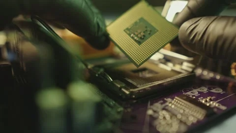 Engineer holding hands CPU to insert into the socket of the motherboard Stock Footage 284204810