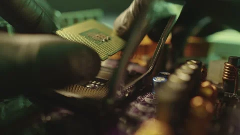 Engineer holding hands CPU to insert into the socket of the motherboard Stock Footage 284204918