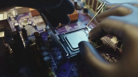 Engineer holding hands CPU to insert into the socket of the motherboard Stock Footage 284204982