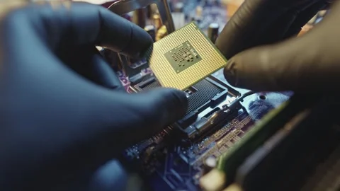 Engineer holding hands CPU to insert into the socket of the motherboard Stock Footage 284205018
