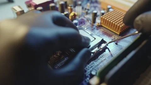 Engineer holding hands CPU to insert into the socket of the motherboard Stock Footage 284205057