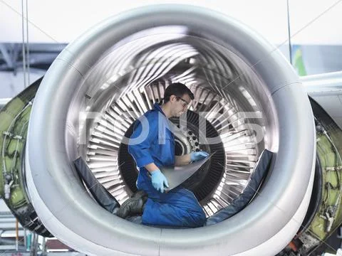 Engineer Holding Jet Engine Turbine Blade In Aircraft Maintenance Factory