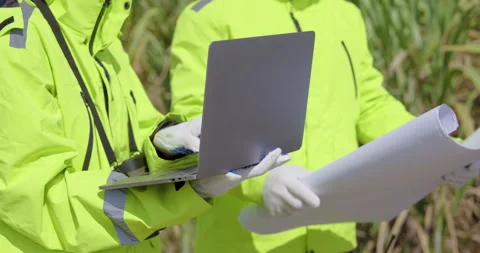 Engineer holding laptop and blueprint checking project details renewable energy 動画素材 325842485