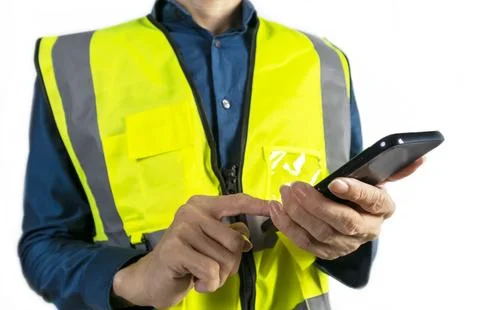 Engineer holding mobile phone to view work data and check work Stock Photos