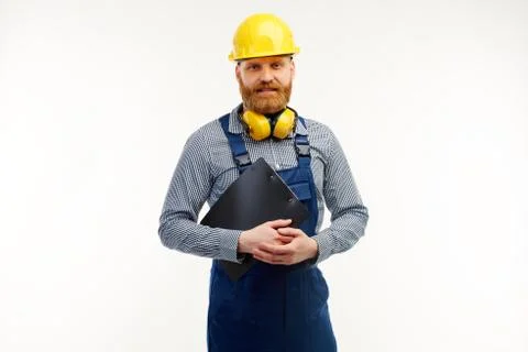 Engineer is holding a notepad and looking at the camera Stock Photos