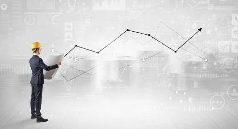 Engineer holding a plan and standing with graphs, charts and reports on the 스톡 사진