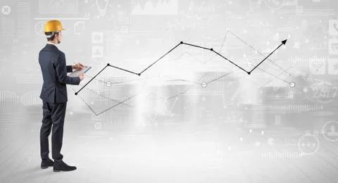 Engineer holding a plan and standing with graphs, charts and reports on the 스톡 사진