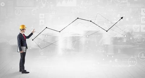 Engineer holding a plan and standing with graphs, charts and reports on the 스톡 사진