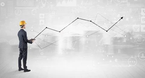 Engineer holding a plan and standing with graphs, charts and reports on the 스톡 사진