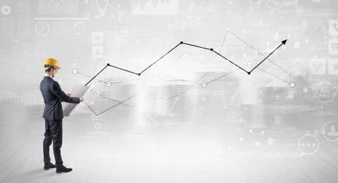 Engineer holding a plan and standing with graphs, charts and reports on the 스톡 사진