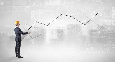 Engineer holding a plan and standing with graphs, charts and reports on the 스톡 사진