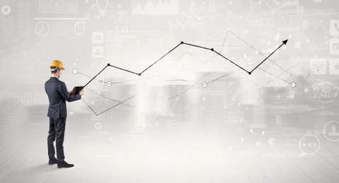 Engineer holding a plan and standing with graphs, charts and reports on the 스톡 사진