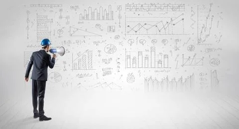 Engineer holding a plan and standing with graphs, charts and reports on the 스톡 사진