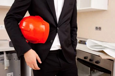 Engineer holding red helmet Stock Photos