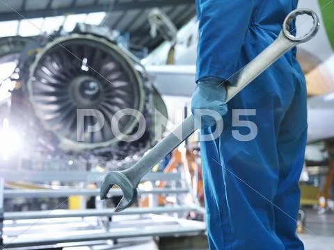 Engineer Holding Spanner In Aircraft Maintenance Factory, Close Up