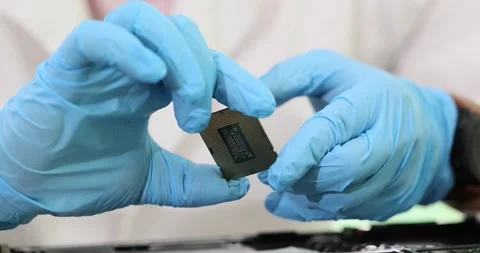 Engineer holds computer microchip in gloves Stock Footage 260678996