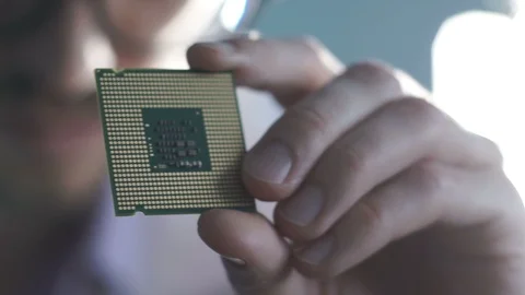 The engineer holds a computer processor Stock Footage 85517899