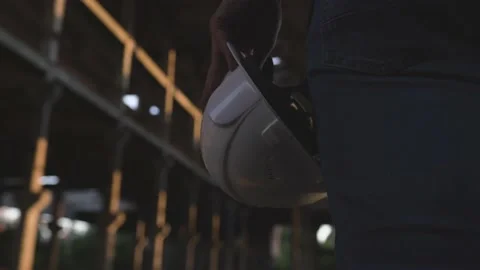 An engineer holds a white helmet in his hand at a construction site Stock Footage 138211839