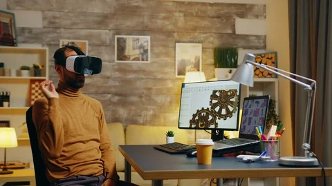 Engineer in home office working in virtual space designing a new model Stock Footage 125849723