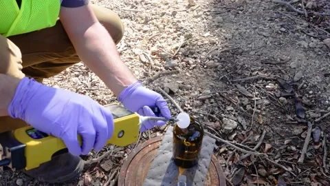Engineer inserts testing probe into sample bottle Stock Footage 168233015