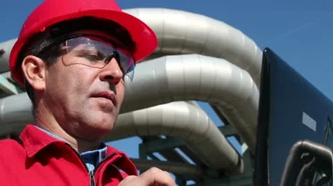 Engineer Inside Oil and Gas Refinery Using Laptop Stock Footage 12366777