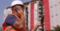 Engineer Inspect Construction Site Talking at Phone and Check Online Information 4k or 4k+ Resolution