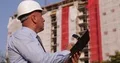 Engineer Inspecting Building Construction Site Look and Take Notes in Agenda 4k or 4k+ Resolution
