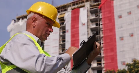 Engineer Inspecting a Building in Construction Take Notes Using Agenda Stock Footage 109114818