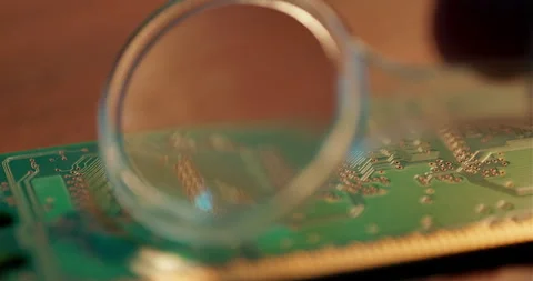 Engineer Inspecting Computer Motherboard Using Magnifying Glass Focused Close Up Stock Footage 336436874