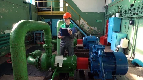 Engineer inspecting machinery water pump in factory Vídeos de archivo 77142103