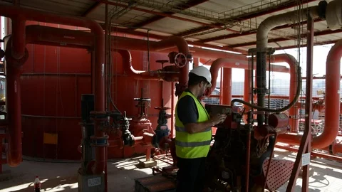 Engineer inspecting machinery water pump. checks the pump sprinklers Stock-Footage 115043793