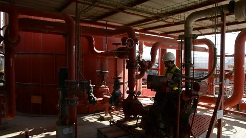 Engineer inspecting machinery water pump. checks the pump sprinklers Видео 115044328