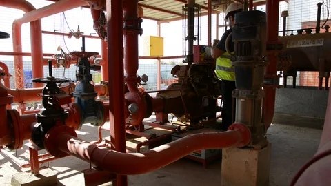 Engineer inspecting machinery water pump. checks the pump sprinklers Stock-Footage 115045130