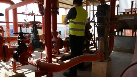 Engineer inspecting machinery water pump. checks the pump sprinklers Stock Footage 115045150