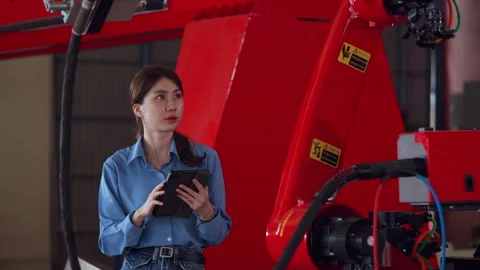 Engineer Inspecting Robotic Arm with Tablet Stock Footage 280744870