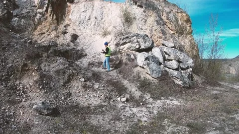 Engineer inspecting rock in surface mine using digital tablet Stock Footage 315243086