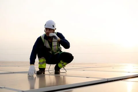 Engineer inspecting solar panel on roof of building, man worker or technici.. Stock Photos