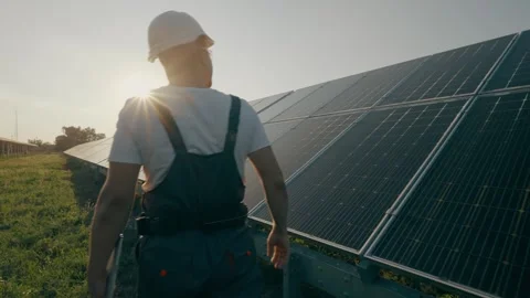 An engineer inspecting solar panels while walking around the station. Stock Footage 264070942