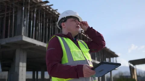 Engineer inspection construction site checking blueprints on tablet. Stock Footage 273494150