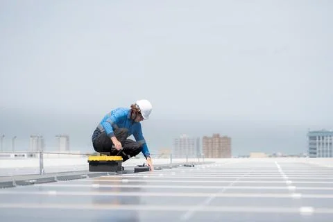 Engineer inspection solar panel installation on rooftop, checking photovolt.. 写真素材