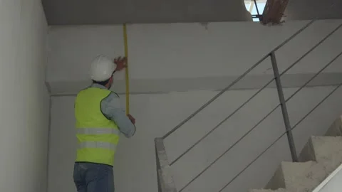 Engineer inspector check and measure high of wall Stock Footage 146681130