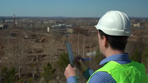 Engineer inspector inspects the territory for the future plant. Video stock 156796761