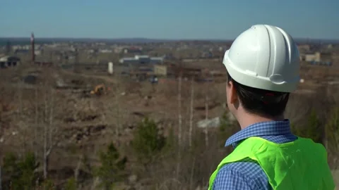 Engineer inspector inspects the territory for the future plant. Video stock 161816917