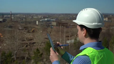 Engineer inspector inspects the territory for the future plant. Video stock 166052944